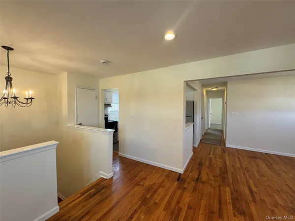 a view of hallway with wooden floor