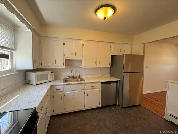 a kitchen with a sink a refrigerator and a stove