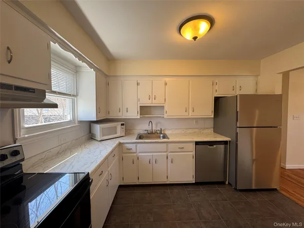 a kitchen with refrigerator and window