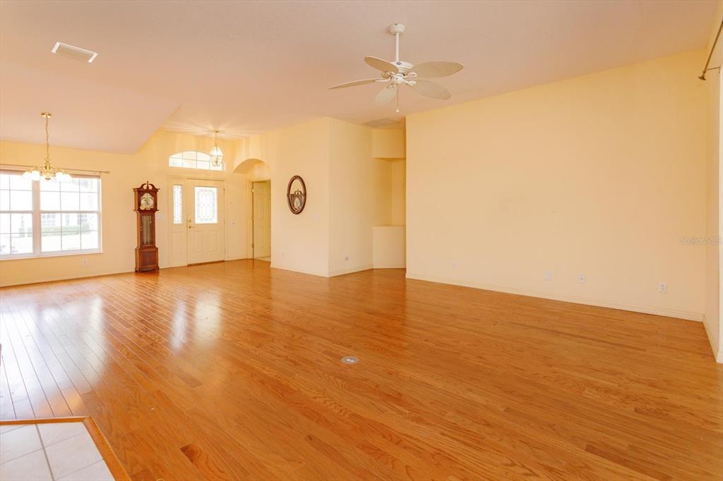 5151 Indian Ocean Loop Tavares, FL 32778 - Photo 14 of 28 an empty room with wooden floor and windows