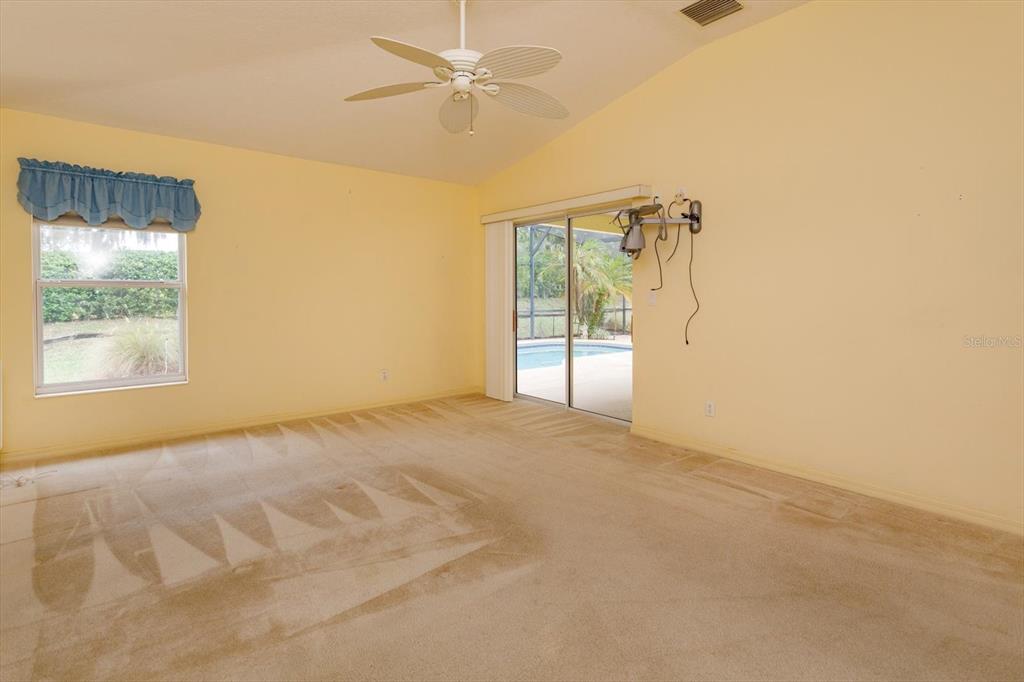 5151 Indian Ocean Loop Tavares, FL 32778 - Photo 16 of 28 en empty room with windows and ceiling fan