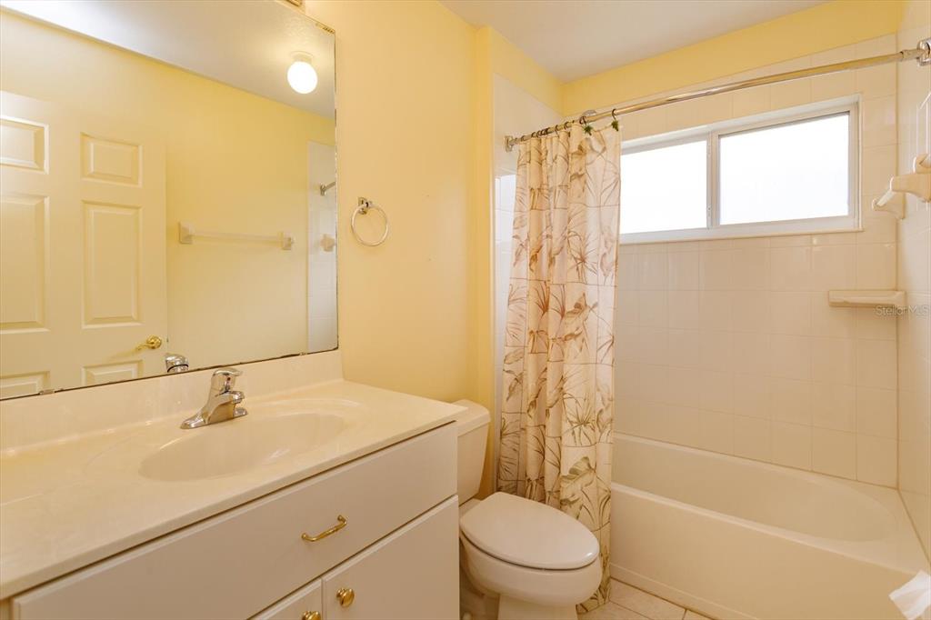 5151 Indian Ocean Loop Tavares, FL 32778 - Photo 21 of 28 a bathroom with a shower sink vanity mirror and toilet