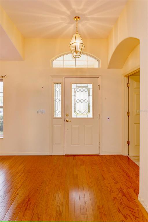 5151 Indian Ocean Loop Tavares, FL 32778 - Photo 5 of 28 a view of an empty room with wooden floor and windows