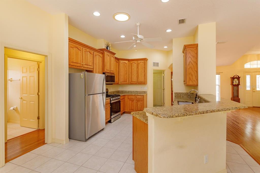 5151 Indian Ocean Loop Tavares, FL 32778 - Photo 8 of 28 a kitchen with stainless steel appliances granite countertop a refrigerator a oven and a sink