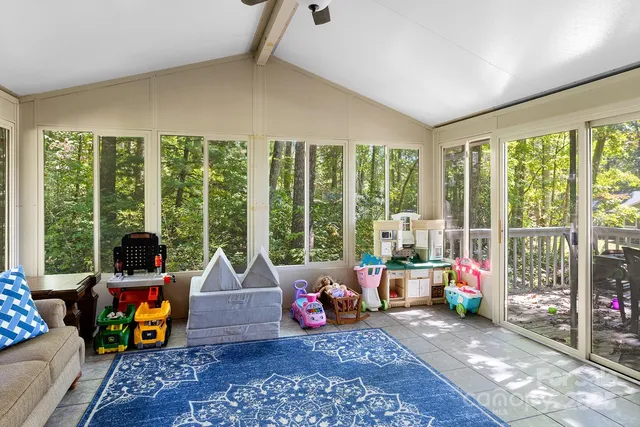 a room with furniture and floor to ceiling windows