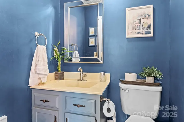 a bathroom with a toilet sink and mirror