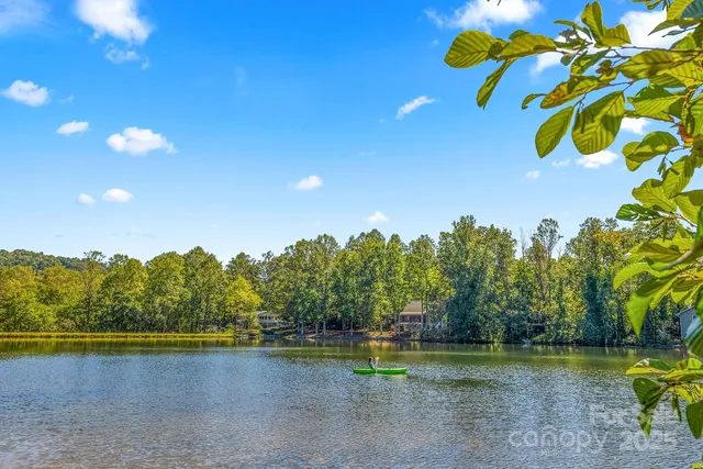 a view of a lake with houses in the background
