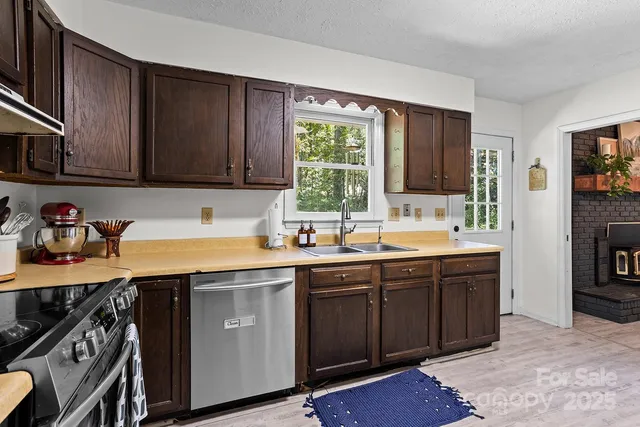 a kitchen with a sink stove and cabinets