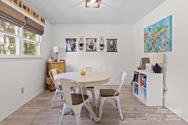 a view of a dining room with furniture and a window