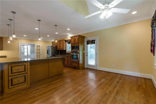 a view of kitchen with sink and wooden floor