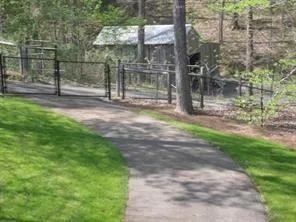 a view of a park with iron fence