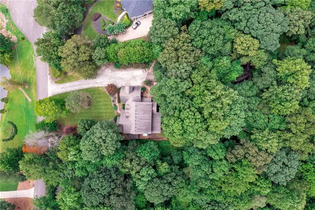 an aerial view of a house with a yard