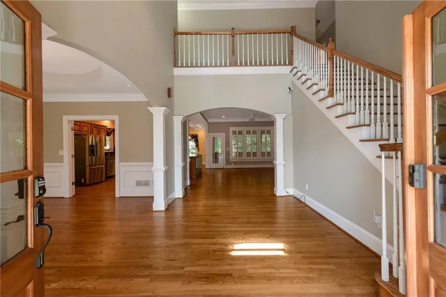 a view of front door and entryway with wooden floor