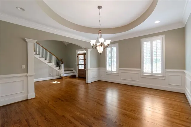 a view of a livingroom with a window and wooden floor