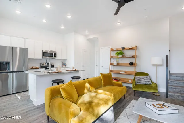 a living room with furniture and a wooden floor