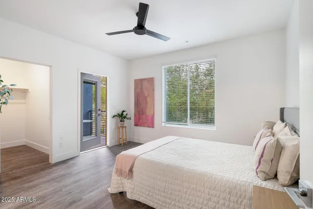 a bedroom with a bed and wooden floor
