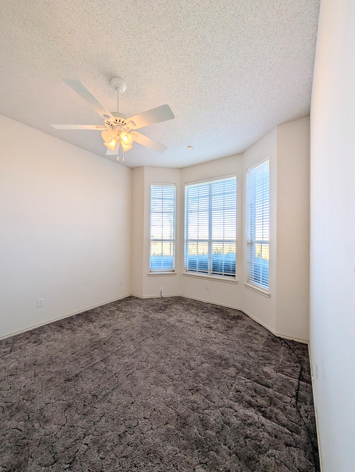 8909 19th Street Lubbock, TX 79407 - Photo 3 of 13 a view of an empty room with a window
