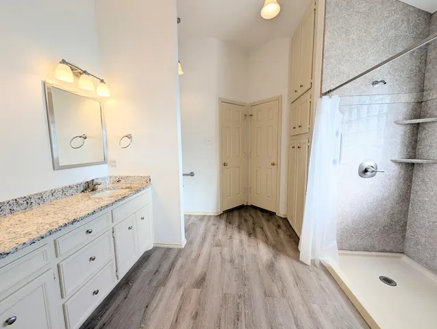 a bathroom with a sink a toilet and shower