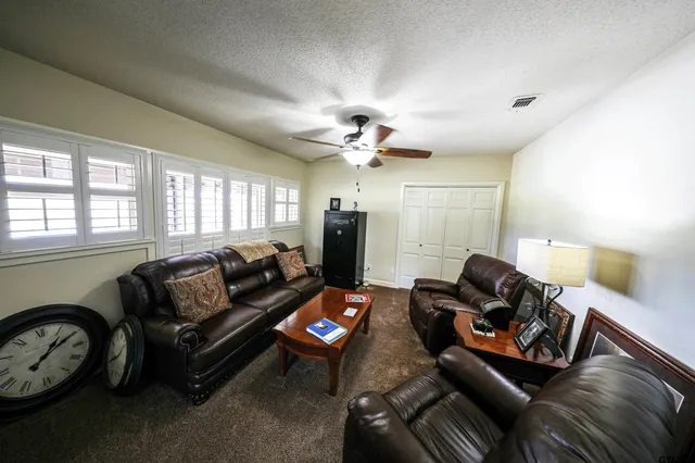 a living room with furniture a air conditioner and a window