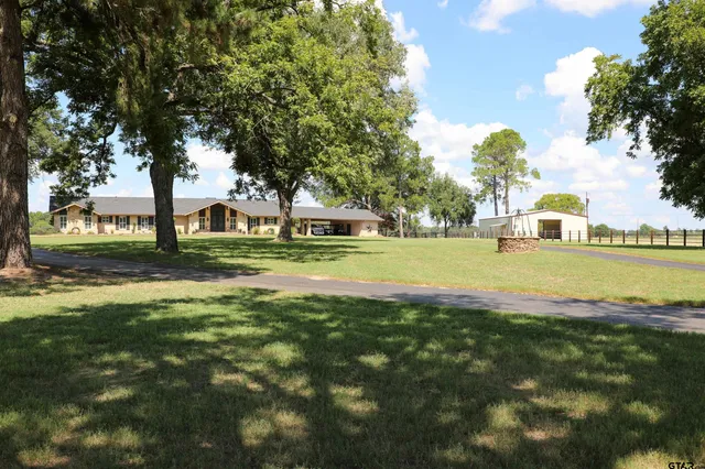 a view of swimming pool with outdoor seating and green space