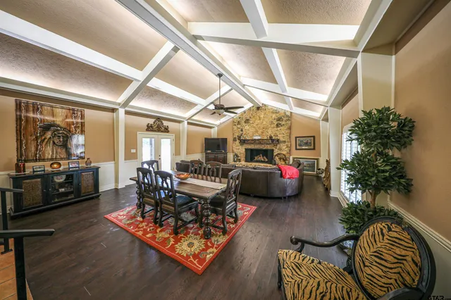 a living room with furniture kitchen view and a potted plant