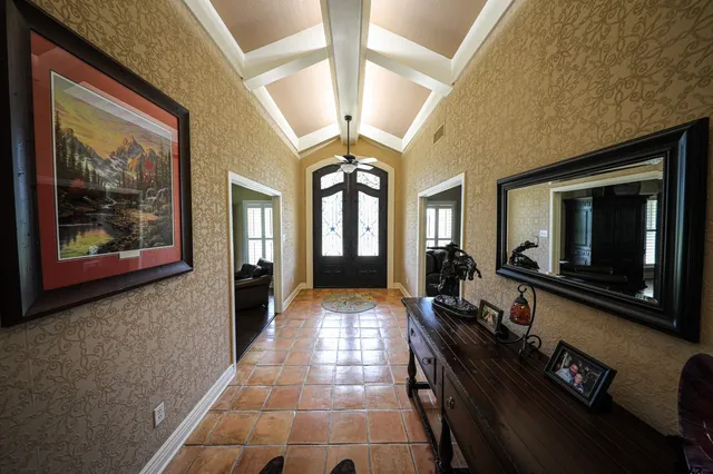 a hallway with beautiful frames and painting on the wall