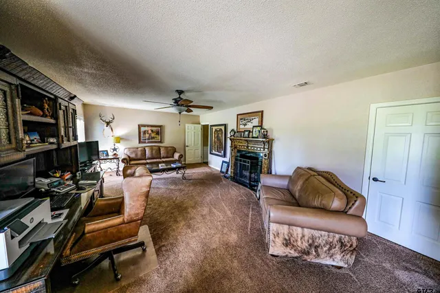 a living room with furniture gym equipment and a flat screen tv