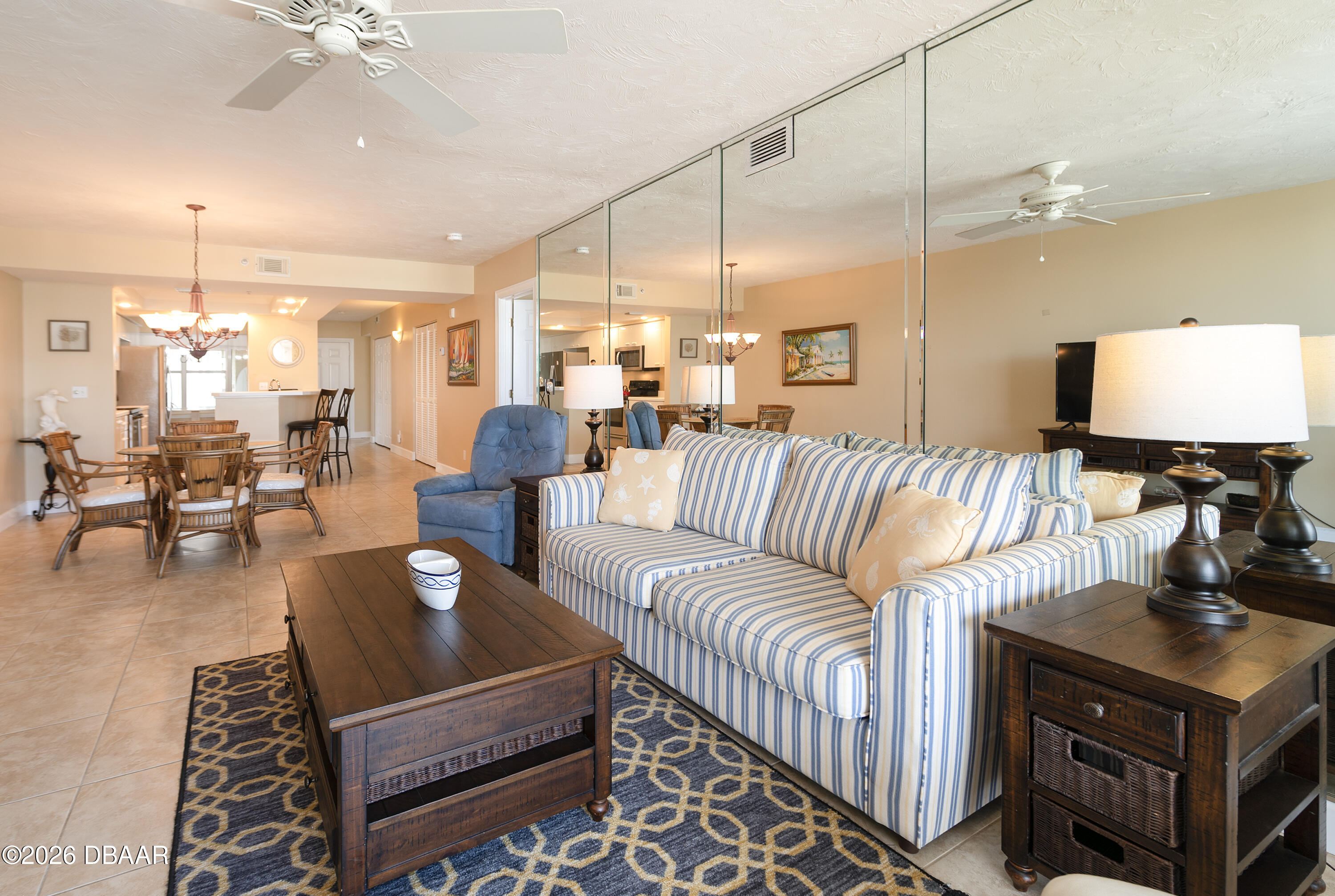 4575 South Atlantic Avenue, Unit 6701 Ponce Inlet, FL 32127 - Photo 7 of 35 a living room with furniture a chandelier and a floor to ceiling window