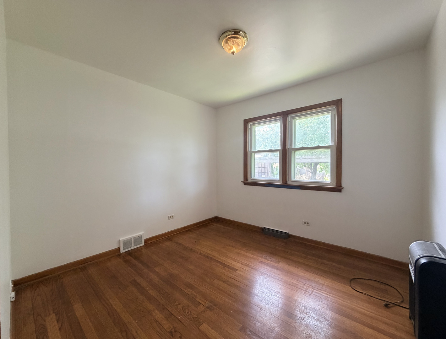128 North York Road Bensenville, IL 60106 - Photo 13 of 39 an empty room with wooden floor and windows