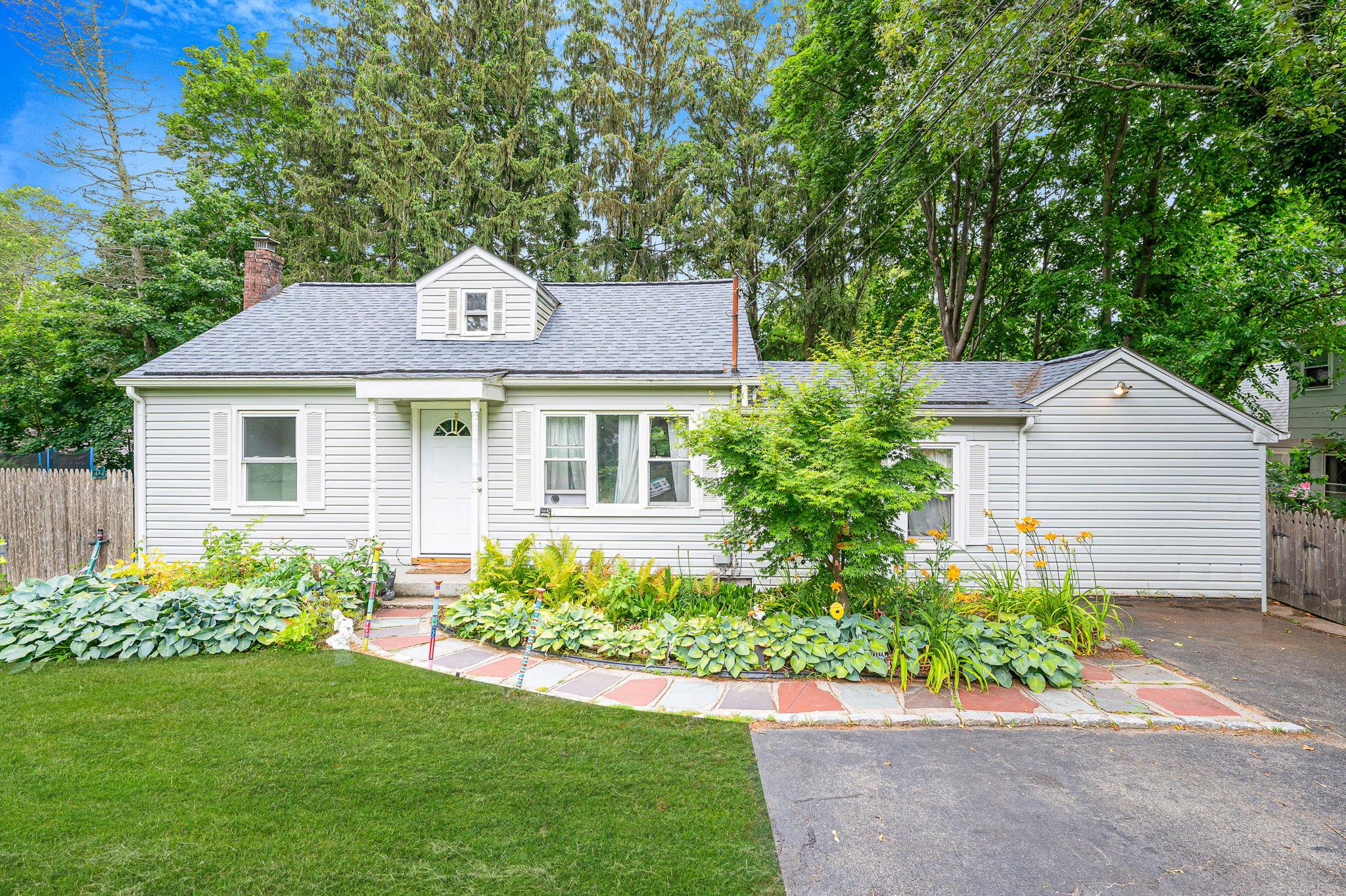 11 Amityville Road Sound Beach, NY 11789 - Photo 1 of 1 a front view of a house with a garden