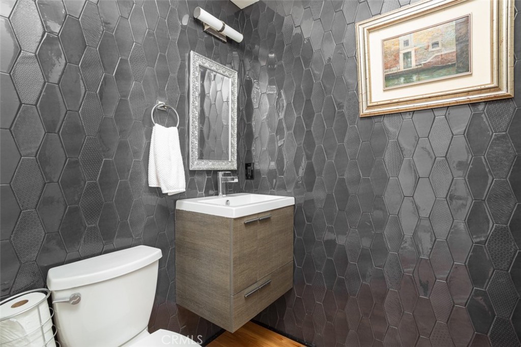 1401 Emerald Bay Laguna Beach, CA 92651 - Photo 11 of 28 a bathroom with a granite countertop sink toilet and a mirror