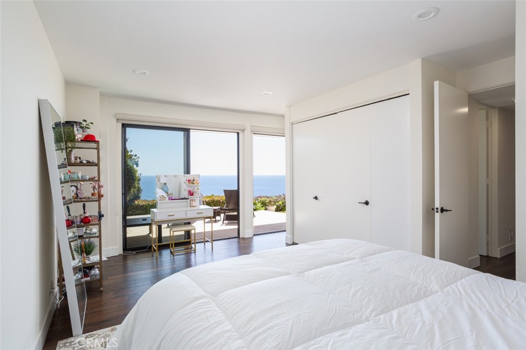 1401 Emerald Bay Laguna Beach, CA 92651 - Photo 16 of 28 a bedroom with a bed a large window and a book shelf