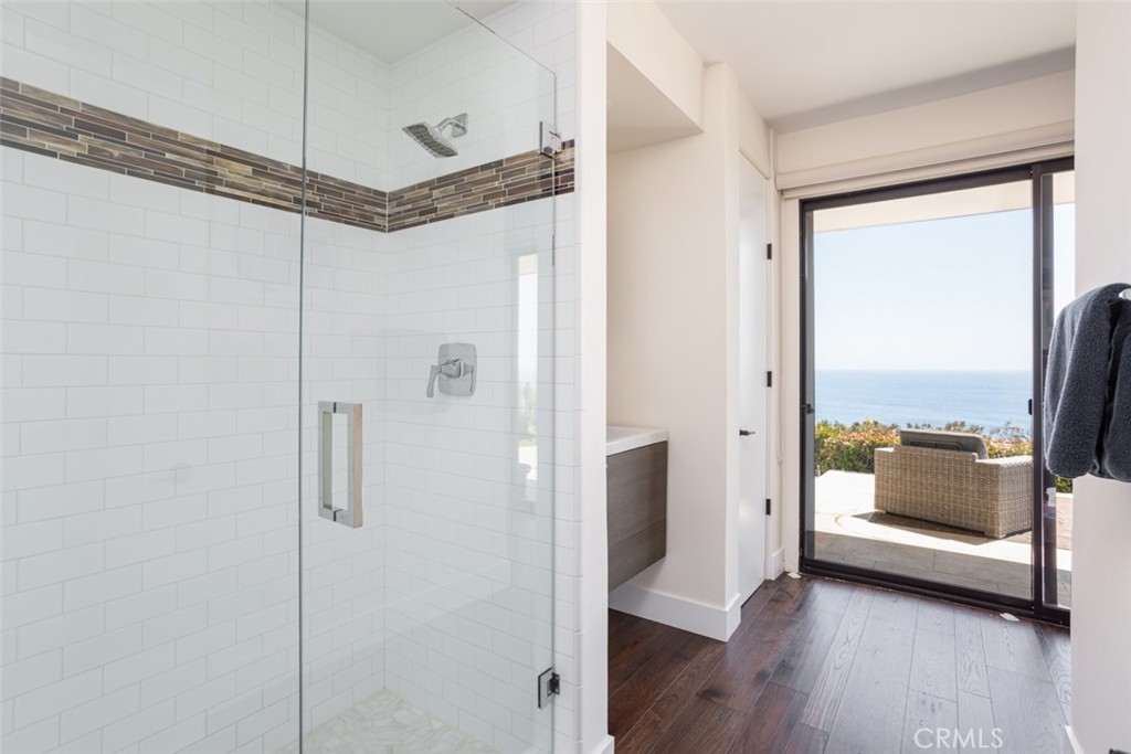 1401 Emerald Bay Laguna Beach, CA 92651 - Photo 19 of 28 a view of a bathroom with a glass shower door and a window