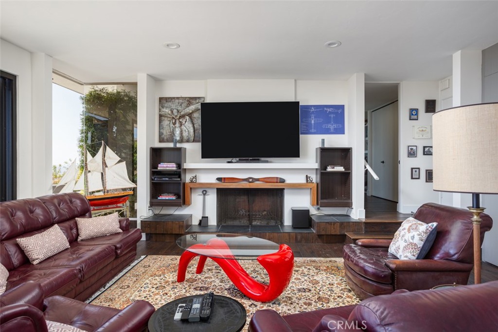 1401 Emerald Bay Laguna Beach, CA 92651 - Photo 24 of 28 a living room with furniture a flat screen tv and a fireplace