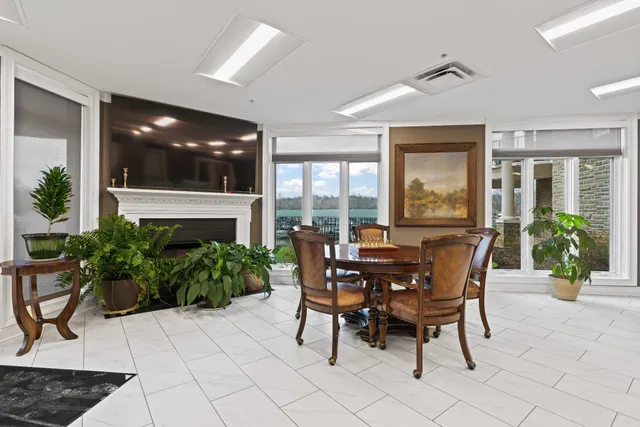 a view of a dining room with furniture and front door