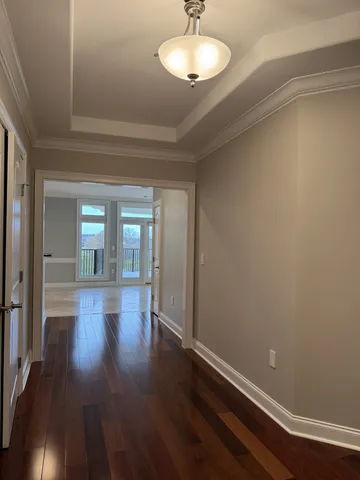 a view of a livingroom with a fireplace a chandelier and entryway