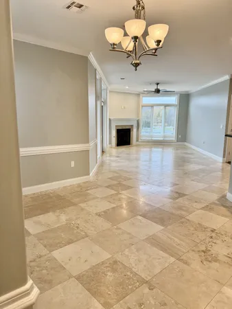 a view of an empty room with a fireplace and a window