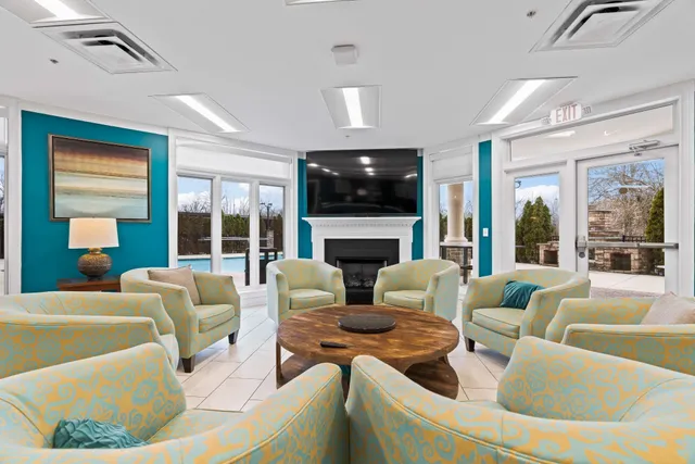 a living room with fireplace furniture and a flat screen tv