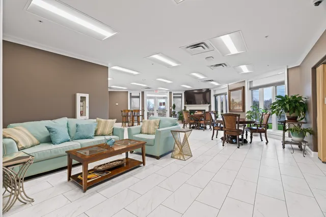 a living room with furniture and a dining table with kitchen view