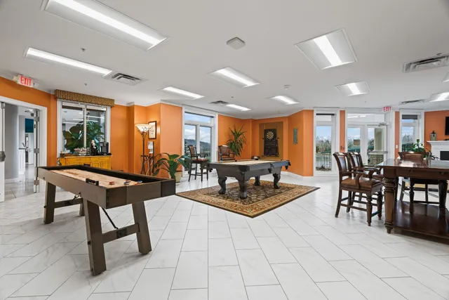 a living room with furniture a table and chairs
