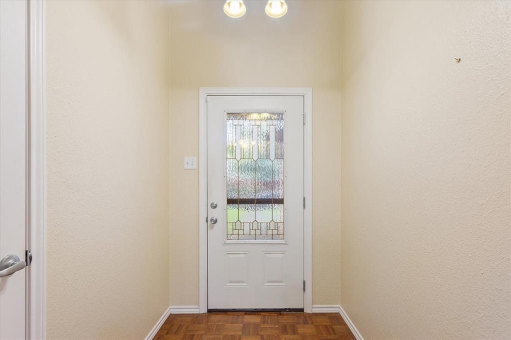 10700 Apache Drive Waco, TX 76712 - Photo 7 of 15 a view of an empty room with wooden floor and windows