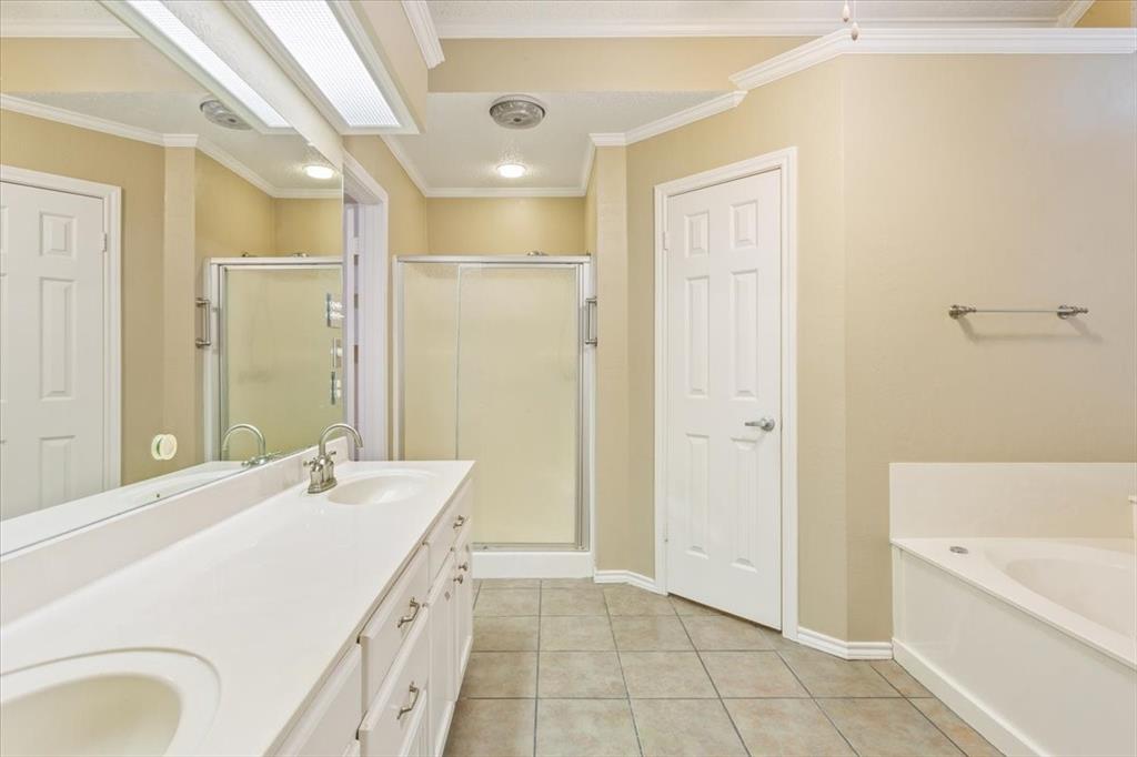 10700 Apache Drive Waco, TX 76712 - Photo 10 of 15 a bathroom with a tub sink and mirror