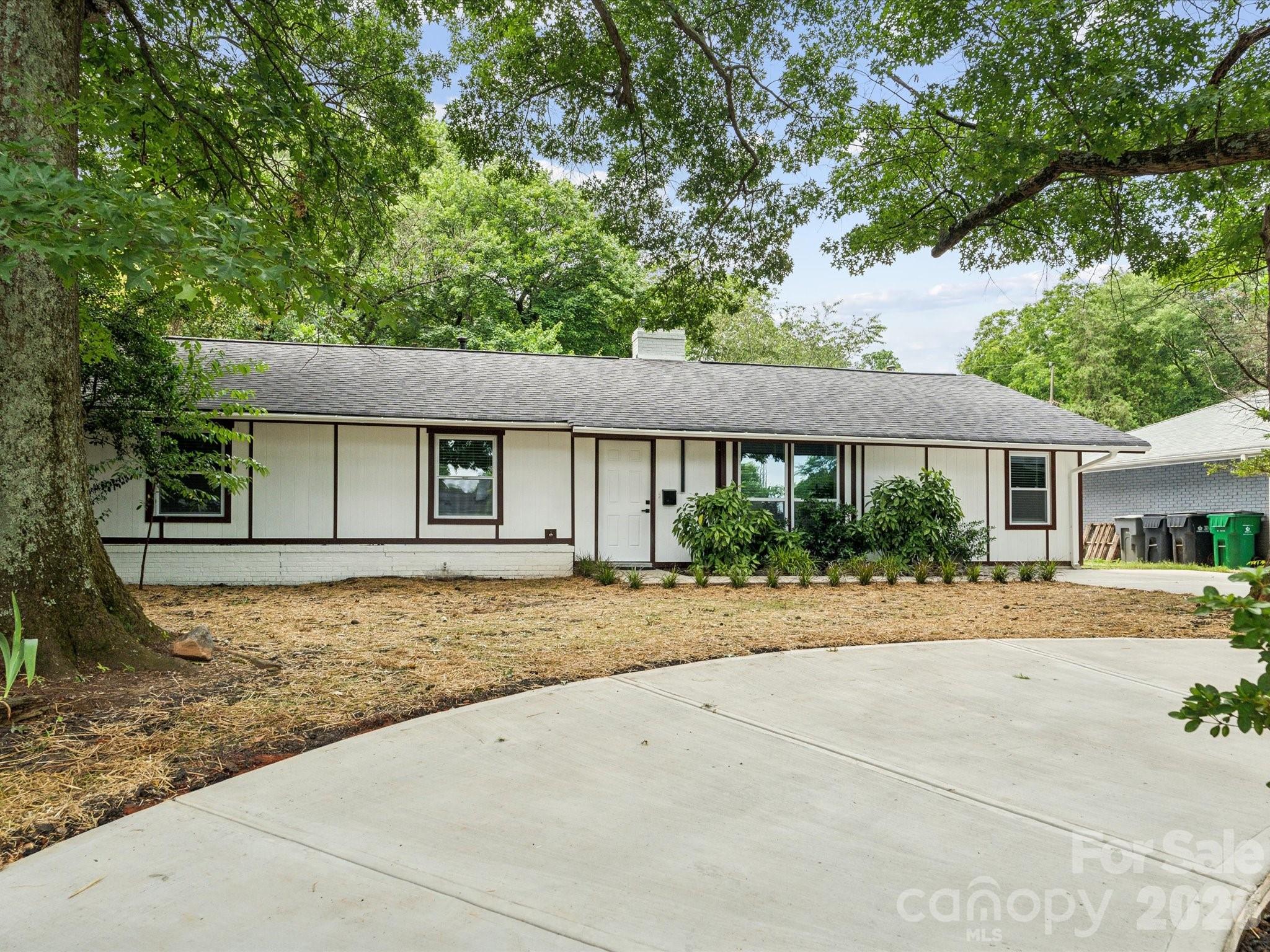 a front view of a house with a yard and a garage