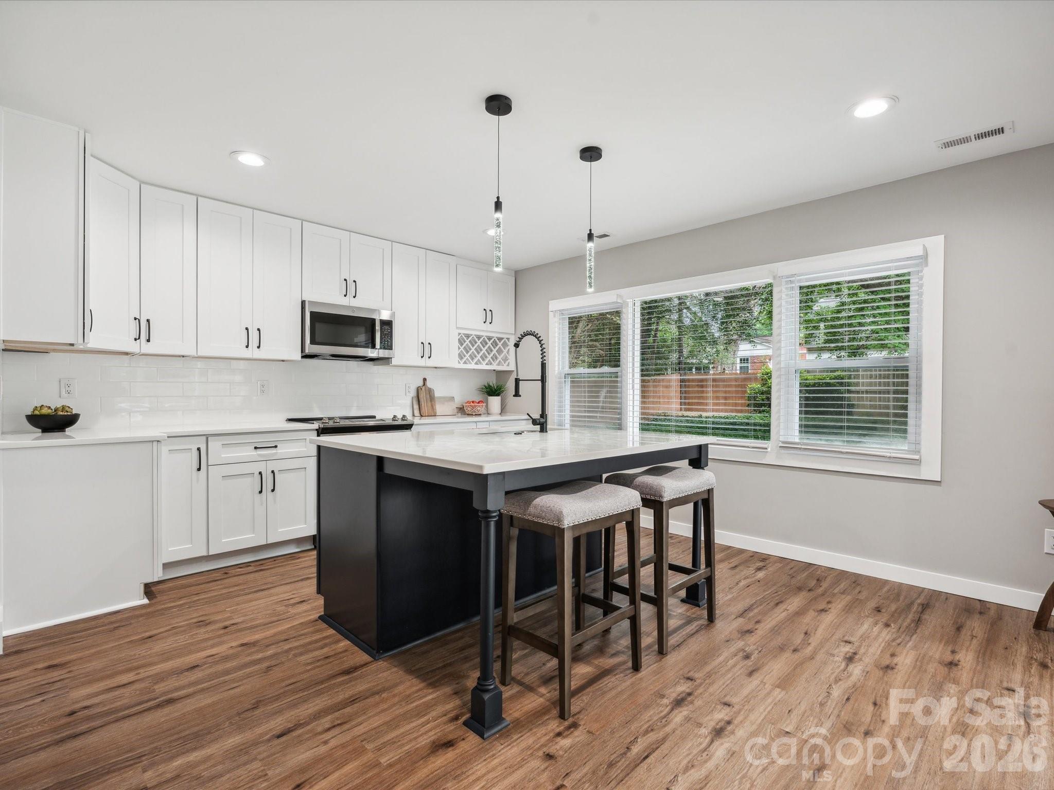 2000 Tyvola Road Charlotte, NC 28210 - Photo 11 of 32 a kitchen with kitchen island granite countertop a sink and counter space