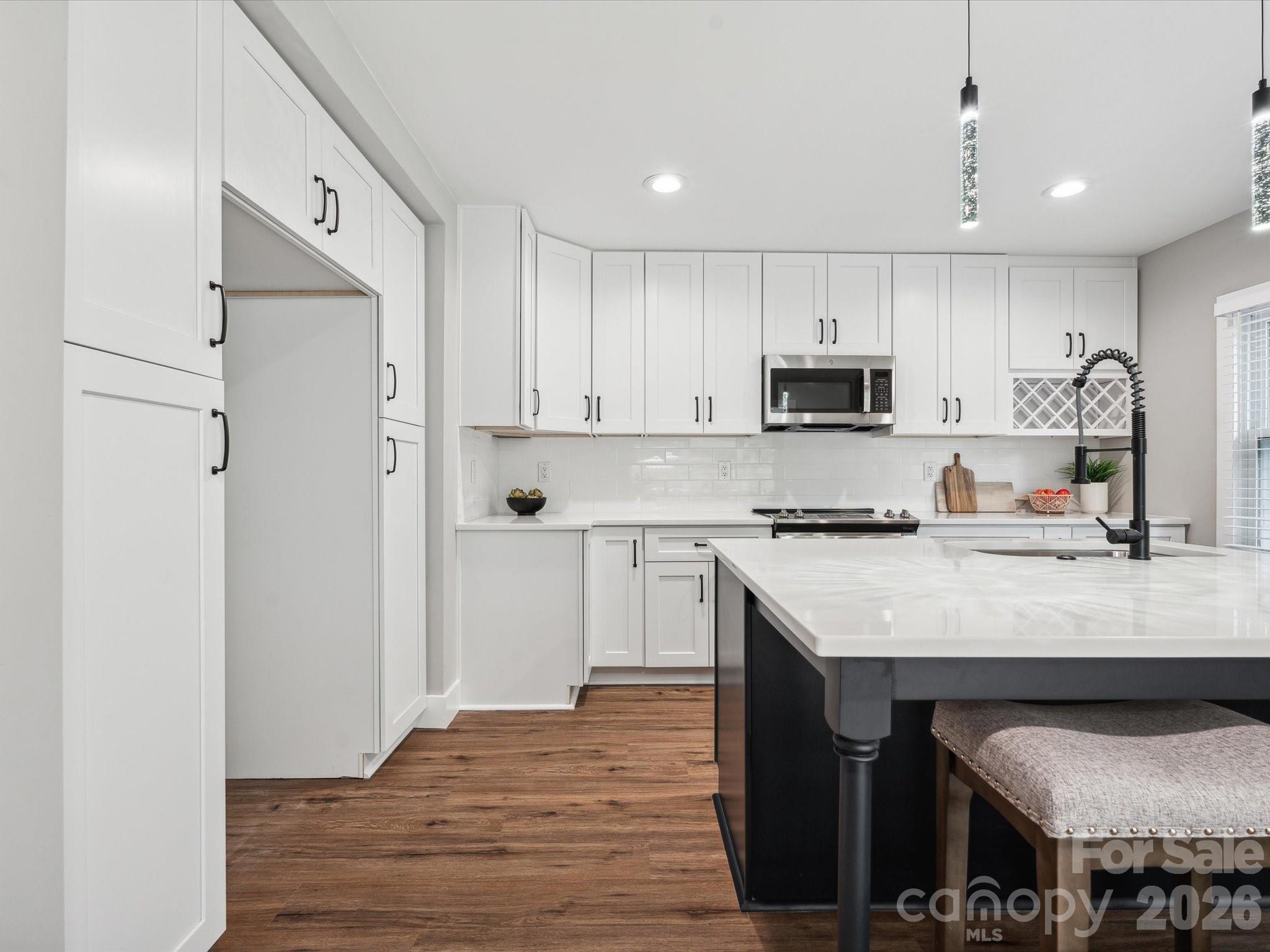 2000 Tyvola Road Charlotte, NC 28210 - Photo 12 of 32 a kitchen with stainless steel appliances granite countertop a refrigerator sink and white cabinets