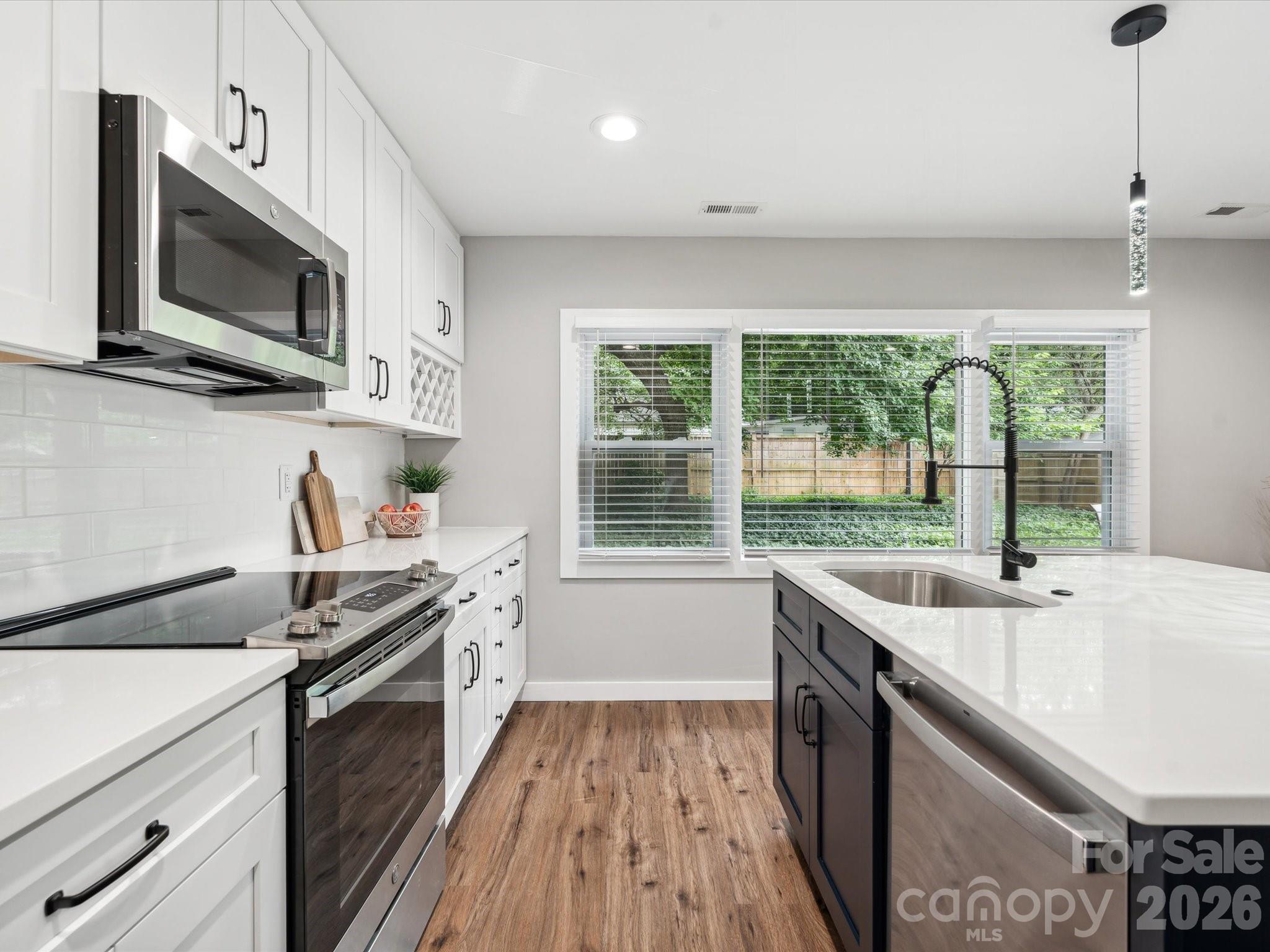 2000 Tyvola Road Charlotte, NC 28210 - Photo 13 of 32 a kitchen that has a sink and a stove top oven