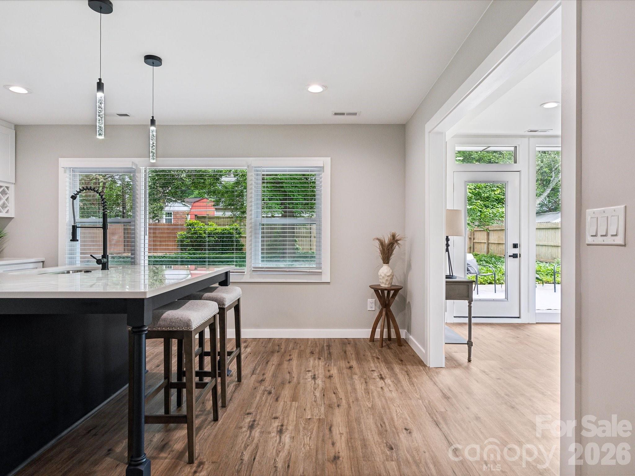 2000 Tyvola Road Charlotte, NC 28210 - Photo 16 of 32 a view of a livingroom with furniture wooden floor and a floor to ceiling window
