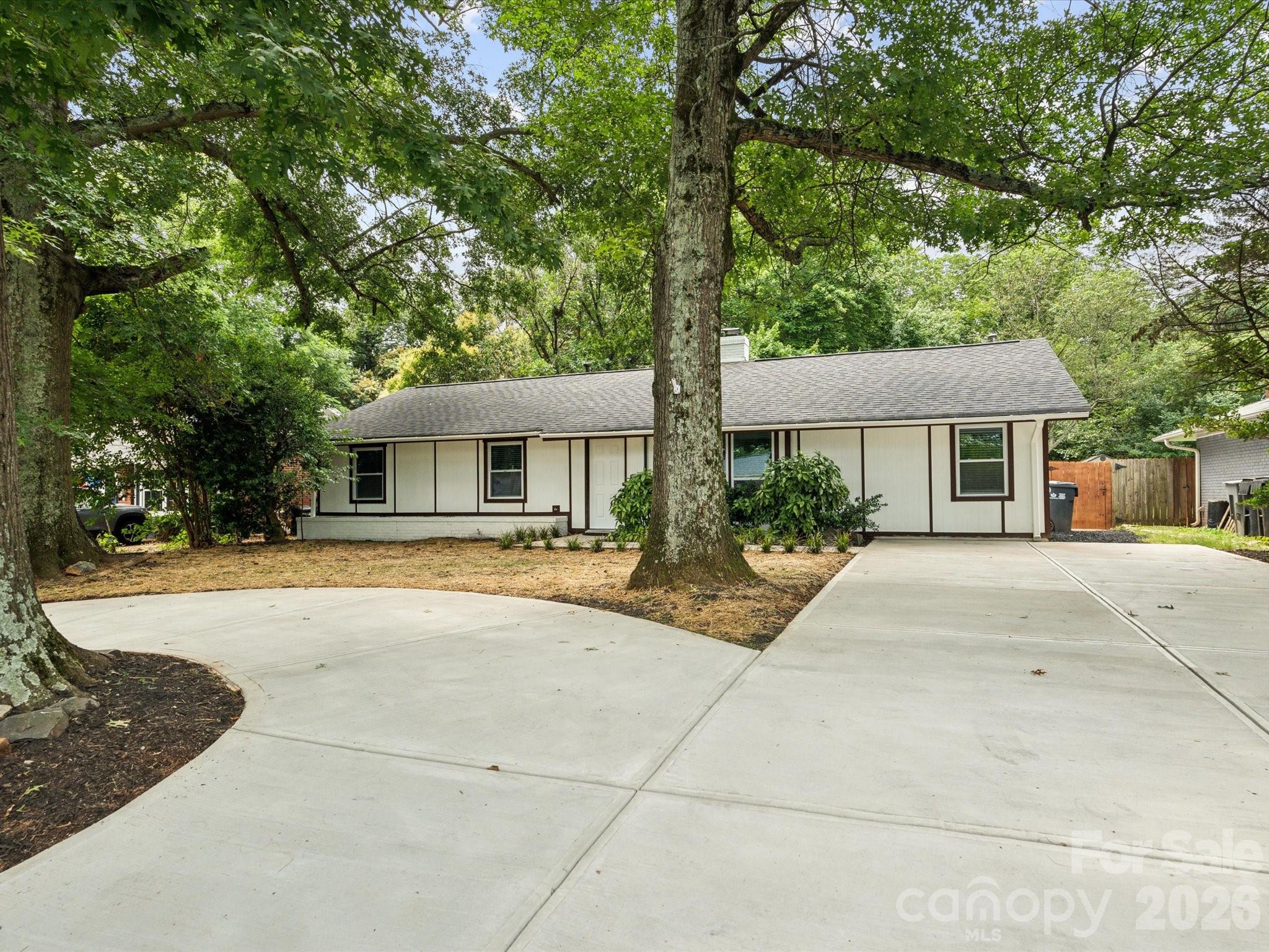 2000 Tyvola Road Charlotte, NC 28210 - Photo 2 of 32 a front view of a house with a yard and trees