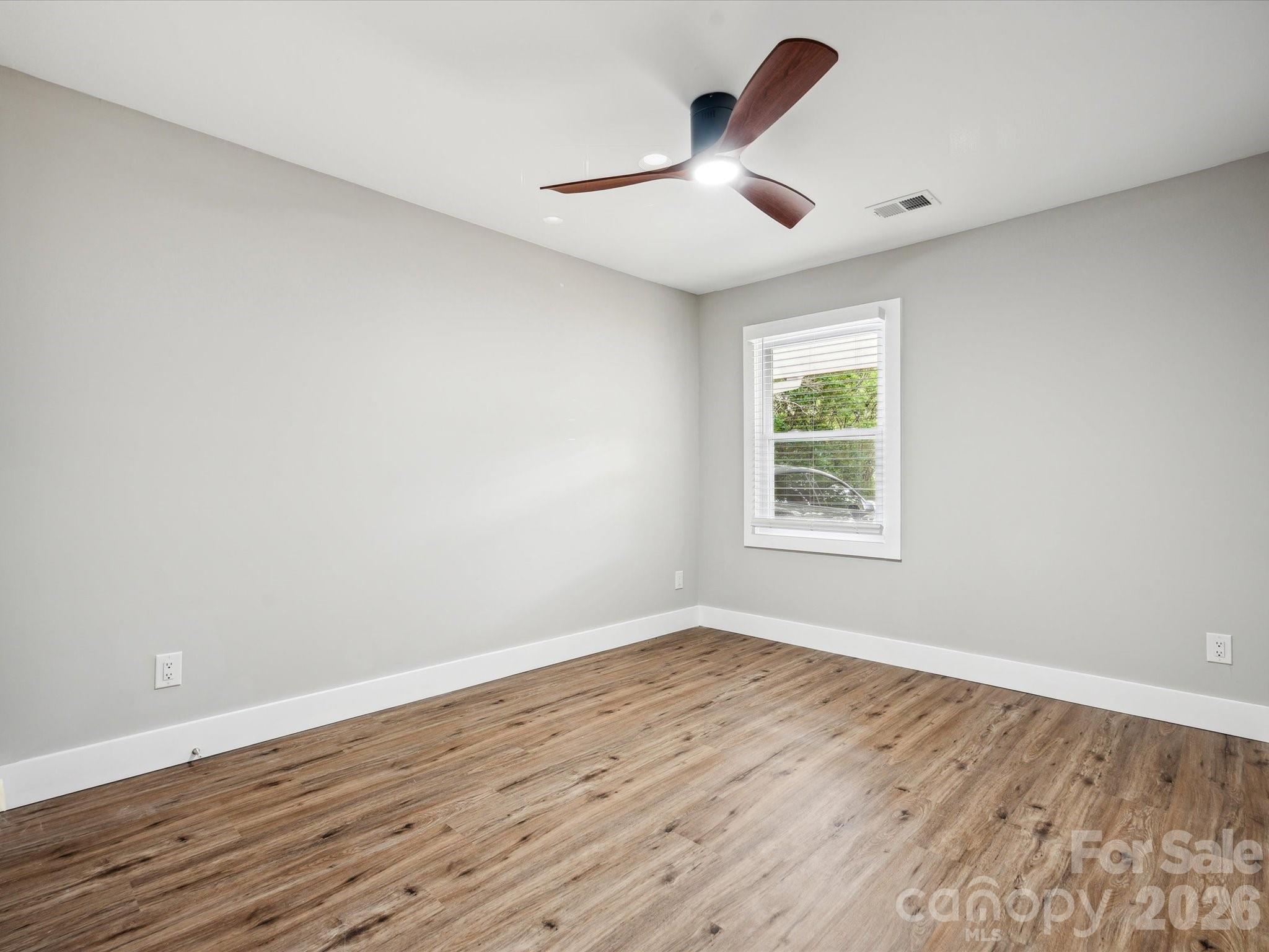 2000 Tyvola Road Charlotte, NC 28210 - Photo 21 of 32 wooden floor in an empty room with a window