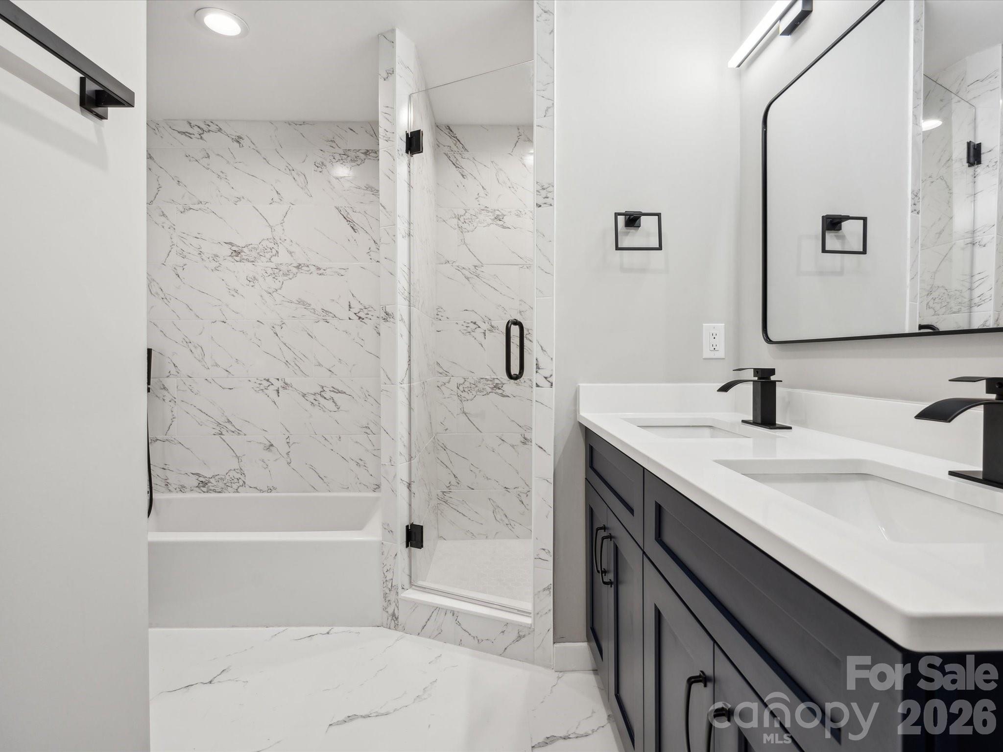 2000 Tyvola Road Charlotte, NC 28210 - Photo 24 of 32 a bathroom with a granite countertop sink a mirror a shower and a bathtub